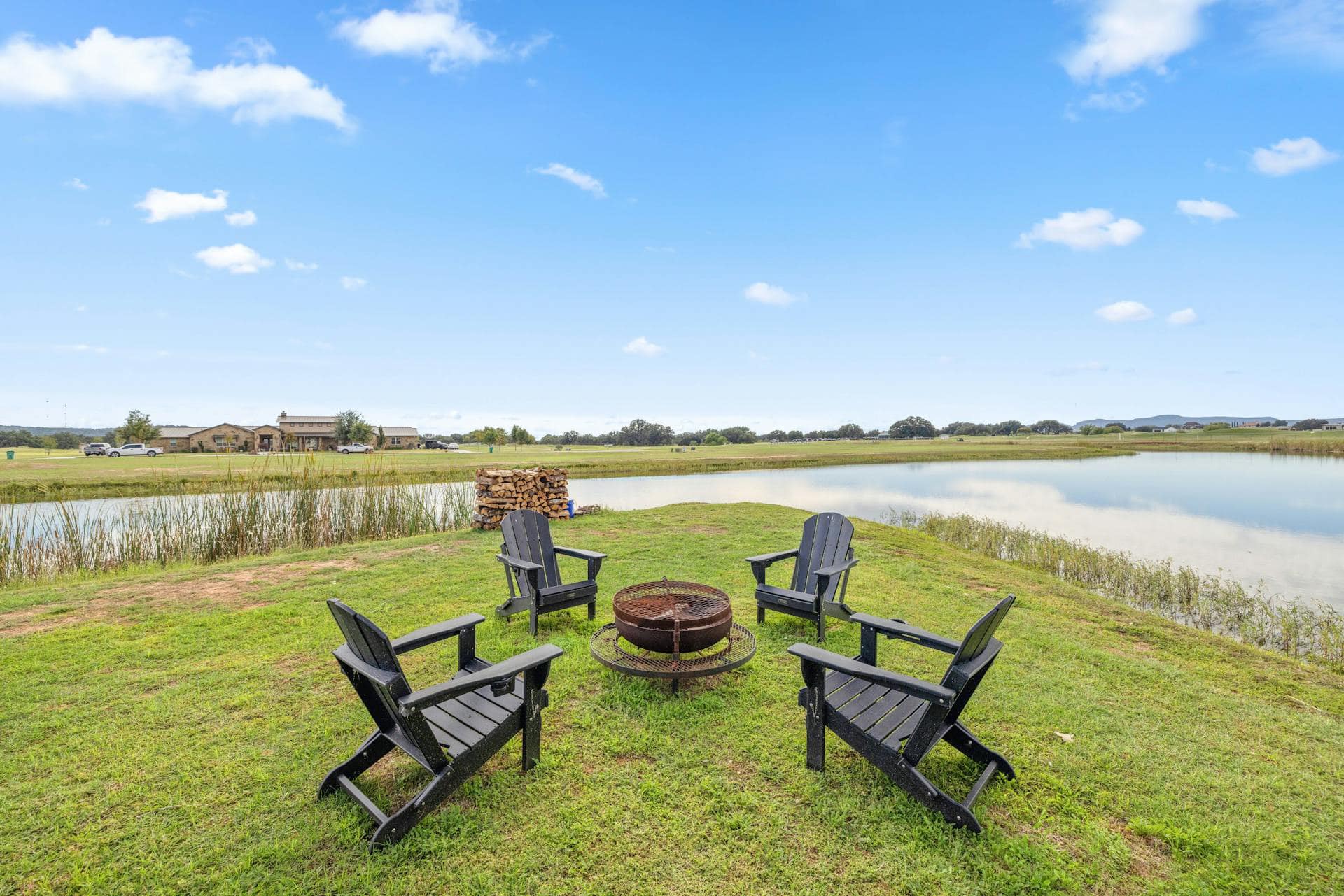 wood fire pit amenity by the pond at legends golf course in kingsland texas